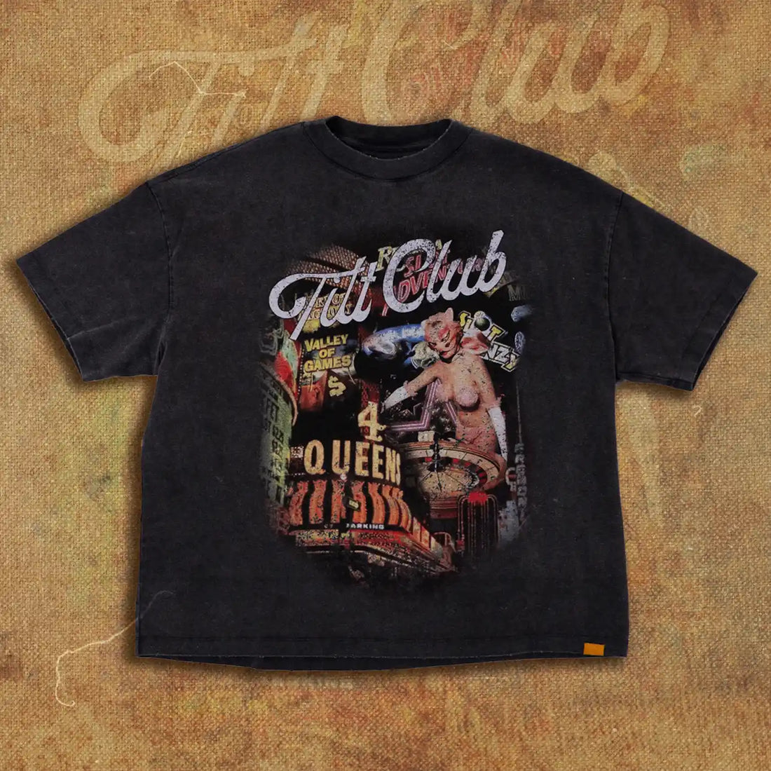 Black t-shirt with a vintage casino-themed graphic design featuring neon signs, a showgirl, and the words 'Tilt Club' above the artwork, inspired by Las Vegas nightlife.